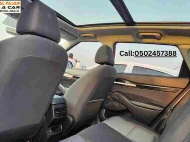 Back seat view of Kia Seltos 2024 red rent a car in Dubai