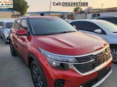 Profile view of Kia Seltos 2024 red rent a car in Dubai